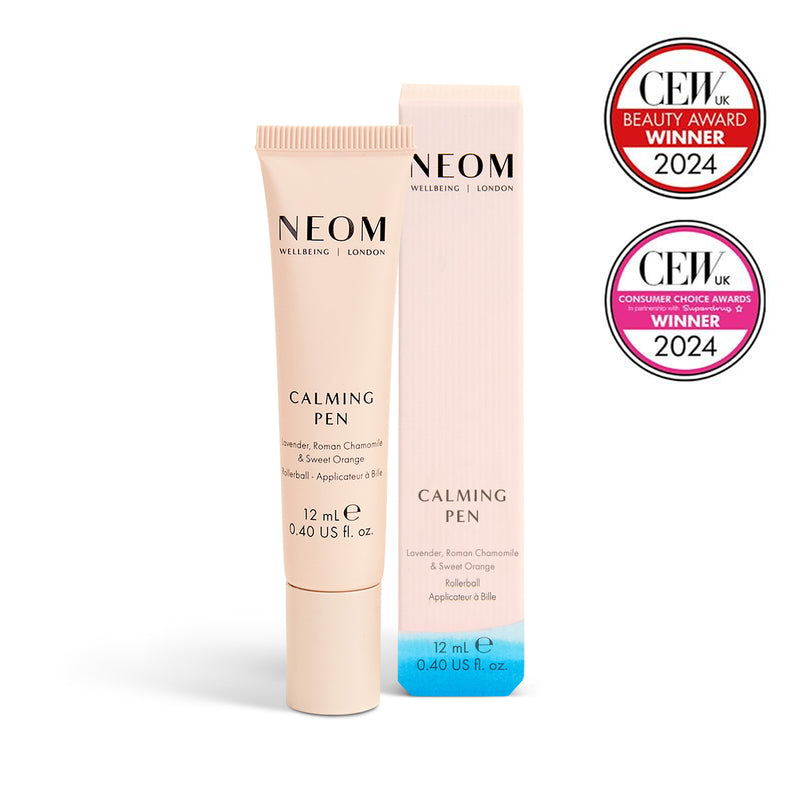 NEOM Calming Pen with packaging and two awards on a white background