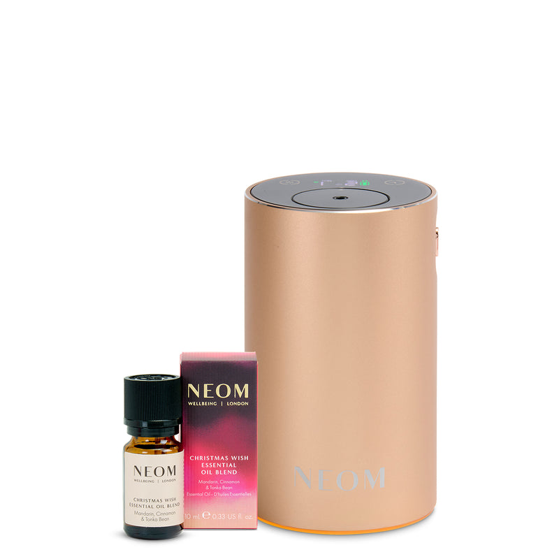 NEOM diffuser and Christmas Wish oil blend on a white background