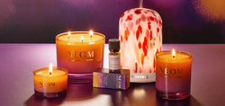 NEOM Cosy Nights Collection with the Limited Edition Clementine Pod Diffuser on a purple and pink background