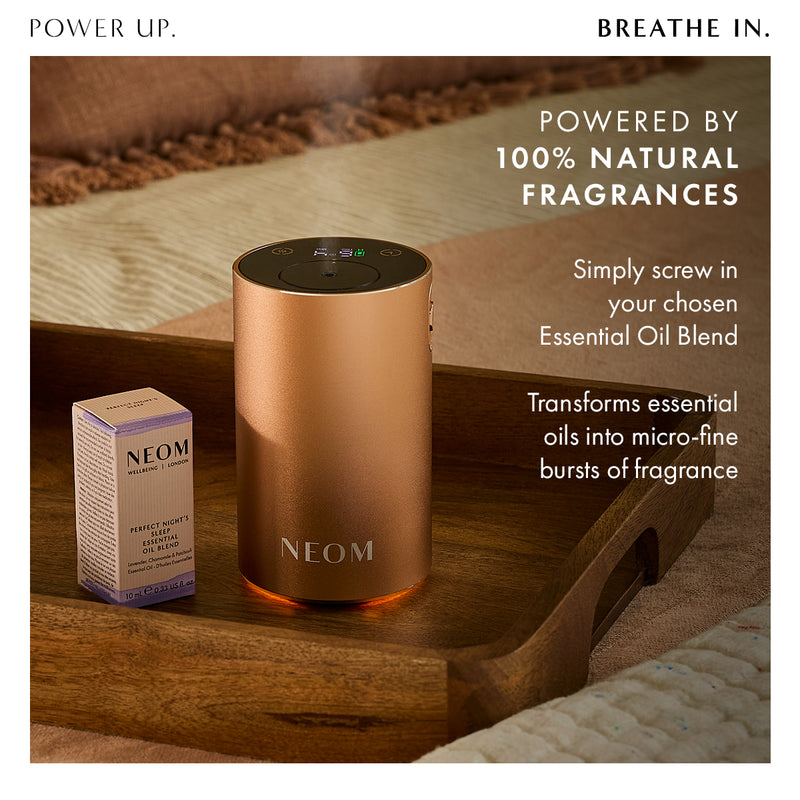 Neom diffuser on a wooden surface with text about natural fragrances