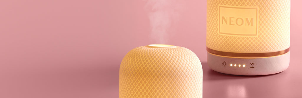NEOM Wellbeing Pod with mist on a pink background