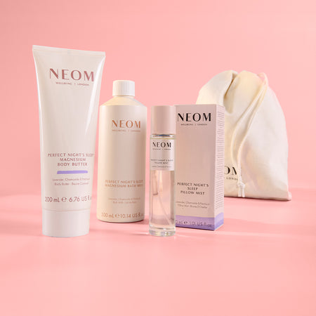 NEOM bath, body and home products on a pink background