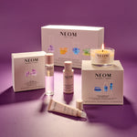 NEOM skincare products including bottles, a candle, and boxes on a purple background