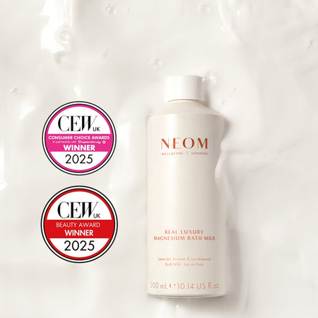NEOM Real Luxury Magnesium Bath Milk on a textured bath milk background