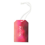 NEOM London gift tag with a pink and purple gradient on a white background