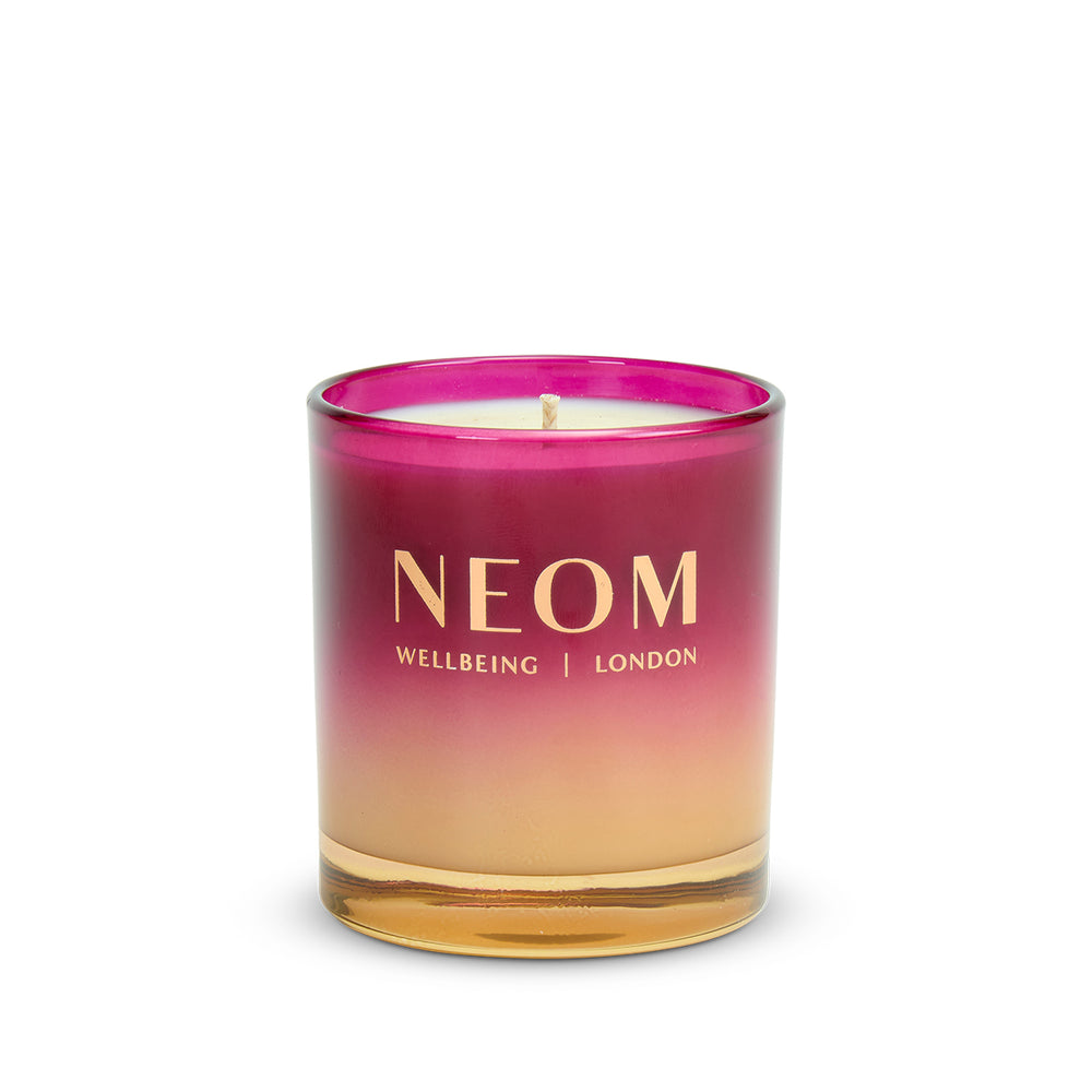 NEOM Christmas Wish 1 Wick Scented Candle with a gradient pink to gold design on a white background