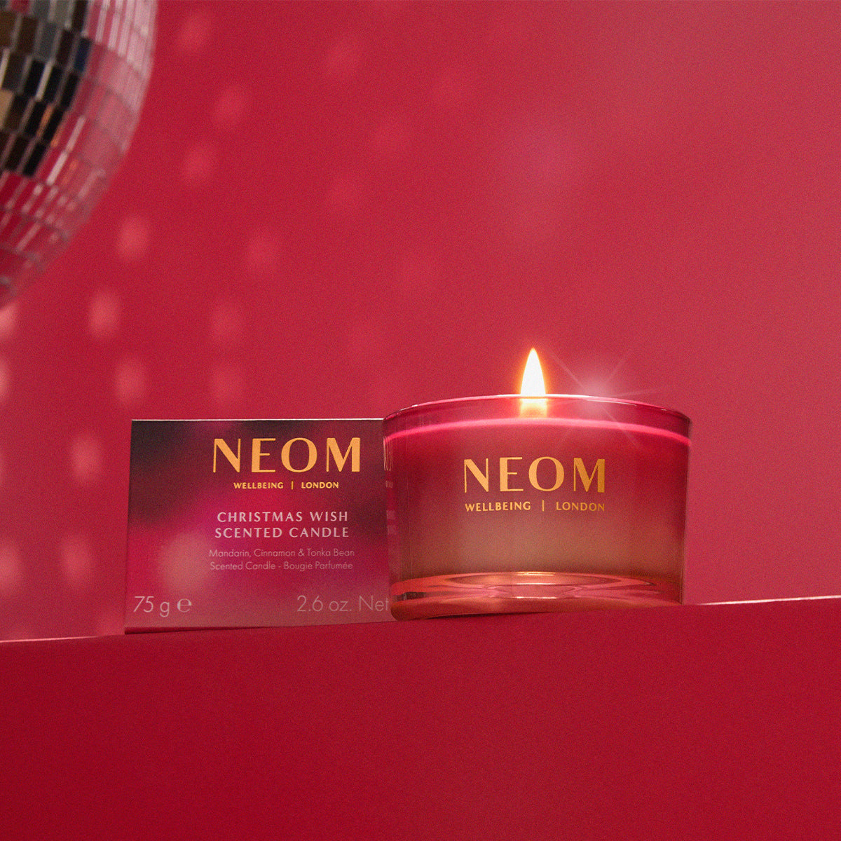 NEOM Christmas Wish scented candle on a red background