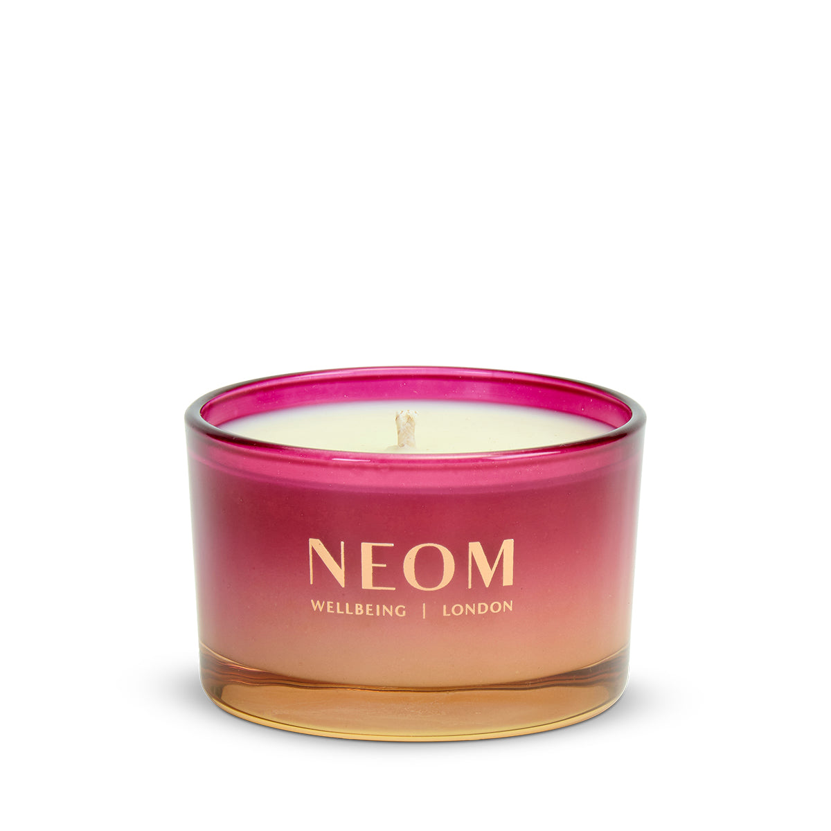 NEOM Christmas Wish Travel Scented Candle with pink and gold design on a white background