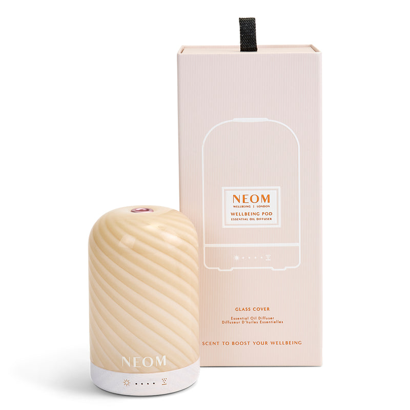 NEOM cinnamon swirl pod essential oil diffuser on a white background