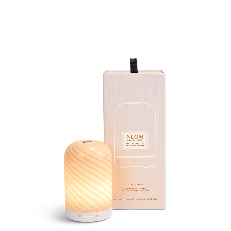 NEOM cinnamon swirl pod essential oil diffuser on a white background
