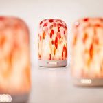 Three NEOM diffusers with a blurred background