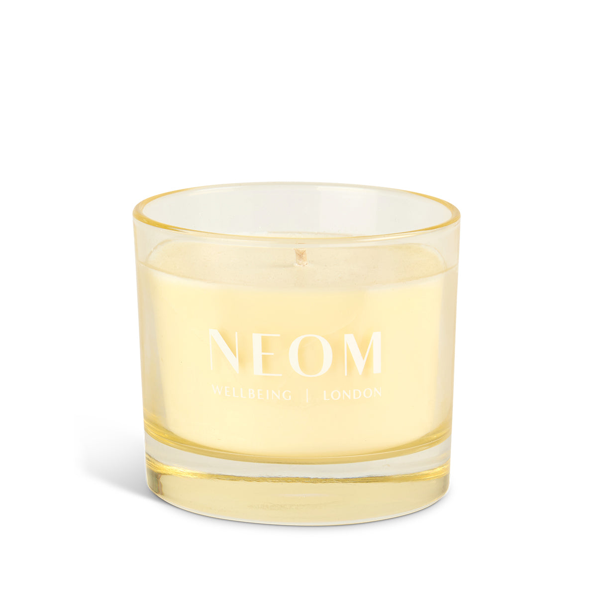 NEOM candle with yellow rim on a white background