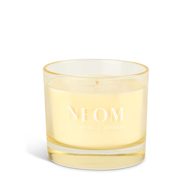 NEOM candle with yellow rim on a white background