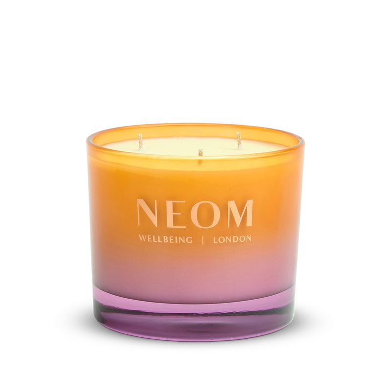 NEOM Cosy Nights 3 Wick Scented Candle with gradient orange to pink design on a white background