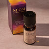 NEOM Cosy Night's essential oil blend and packaging on a neutral background