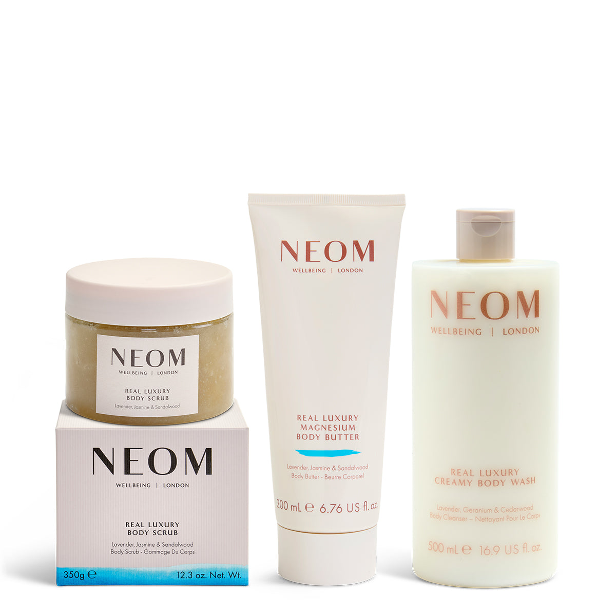 NEOM real luxury body scrub, magnesium body butter and body wash on a white background