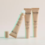 Three of NEOM Energy Pens on a light background