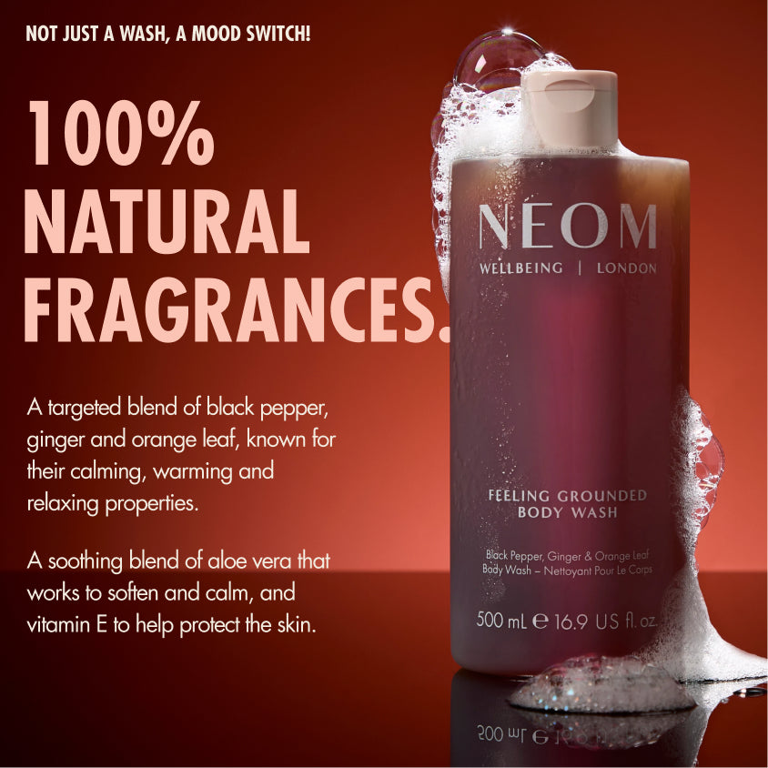 “NEOM Feeling Grounded Body Wash on a red background with foam. Text reads: ‘Not just a wash, a mood switch! 100% natural fragrances.’ Additional text: ‘A targeted blend of black pepper, ginger and orange leaf, known for their calming, warming and relaxing properties. A soothing blend of aloe vera that works to soften and calm, and vitamin E to help protect the skin.’”