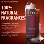 “NEOM Feeling Grounded Body Wash on a red background with foam. Text reads: ‘Not just a wash, a mood switch! 100% natural fragrances.’ Additional text: ‘A targeted blend of black pepper, ginger and orange leaf, known for their calming, warming and relaxing properties. A soothing blend of aloe vera that works to soften and calm, and vitamin E to help protect the skin.’”