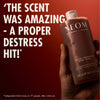 “Hand holding NEOM Feeling Grounded Body Wash against a red background. Large text reads: ‘The scent was amazing – a proper destress hit!’ Small print: ‘*Independent blind study on 77 people, after initial use.’”