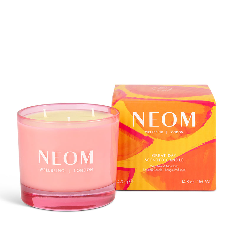 Pink NEOM candle with packaging on a white background