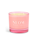 Pink NEOM candle on a white background