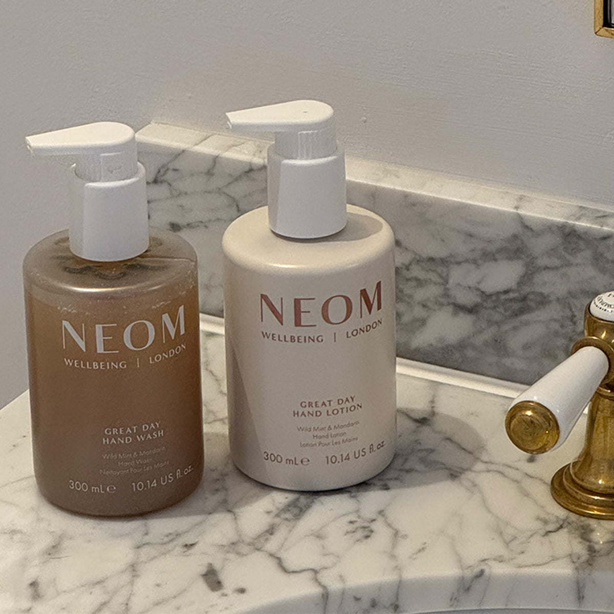 NEOM great day hand wash and hand lotion in a a bathroom beside a sink