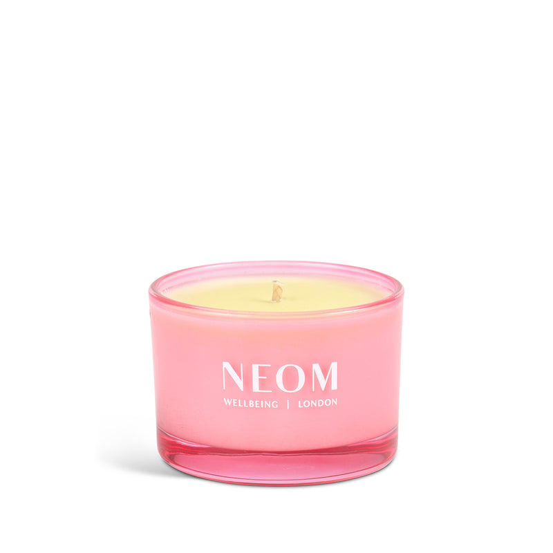 Pink NEOM candle on a white background