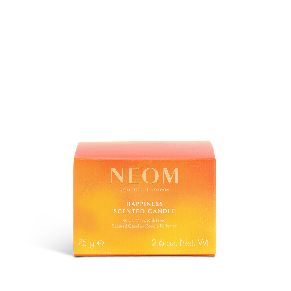 NEOM Happiness scented travel candle packaging on a white background