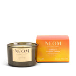 NEOM limited-edition happiness scented travel candle with packaging on a white background