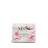 NEOM scented candle packaging with floral design on a white background
