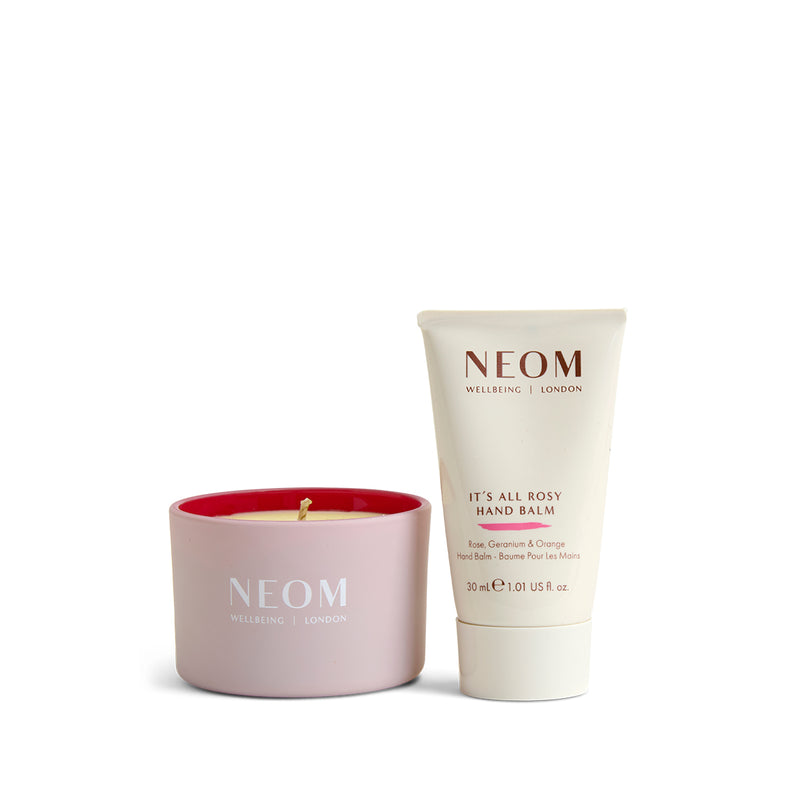 NEOM candle and hand balm on a white background
