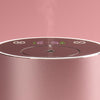 Close-up of a pink NEOM diffuser with control panel on a pink background