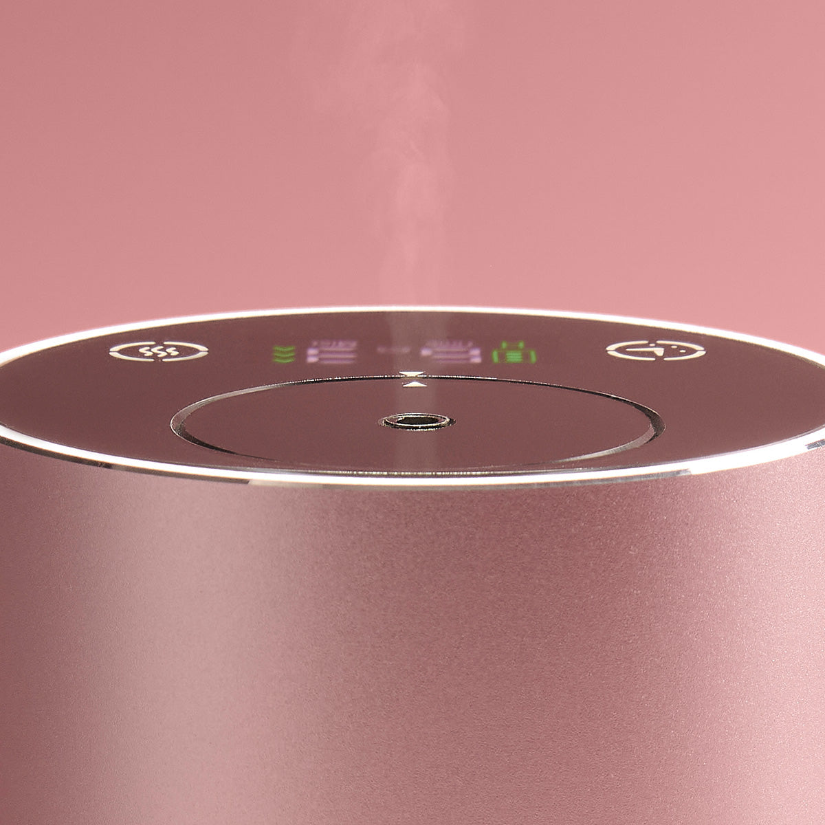 Close-up of a pink NEOM diffuser with control panel on a pink background
