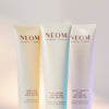 Three NEOM magnesium body butters on a gradient background