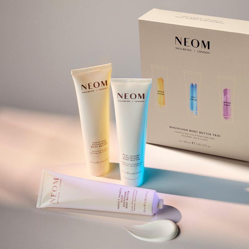 Three NEOM magnesium body butters on a light background