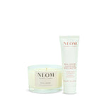 NEOM Real Luxury magnesium body butter and Real Luxury Travel candle on a white background