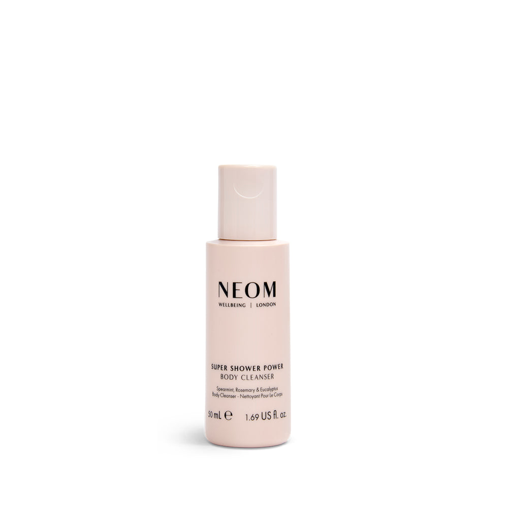 A 50ml bottle of NEOM Super Shower Power Body Cleanser with a white label and pink packaging.