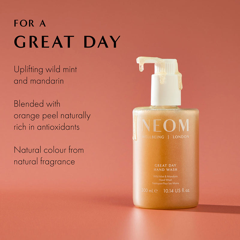NEOM Great Day Hand Wash with wild mint and mandarin, natural antioxidant skincare on coral background