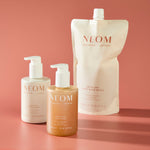NEOM Great Day hand wash refill pouch with lotion and wash bottles, sustainable skincare packaging