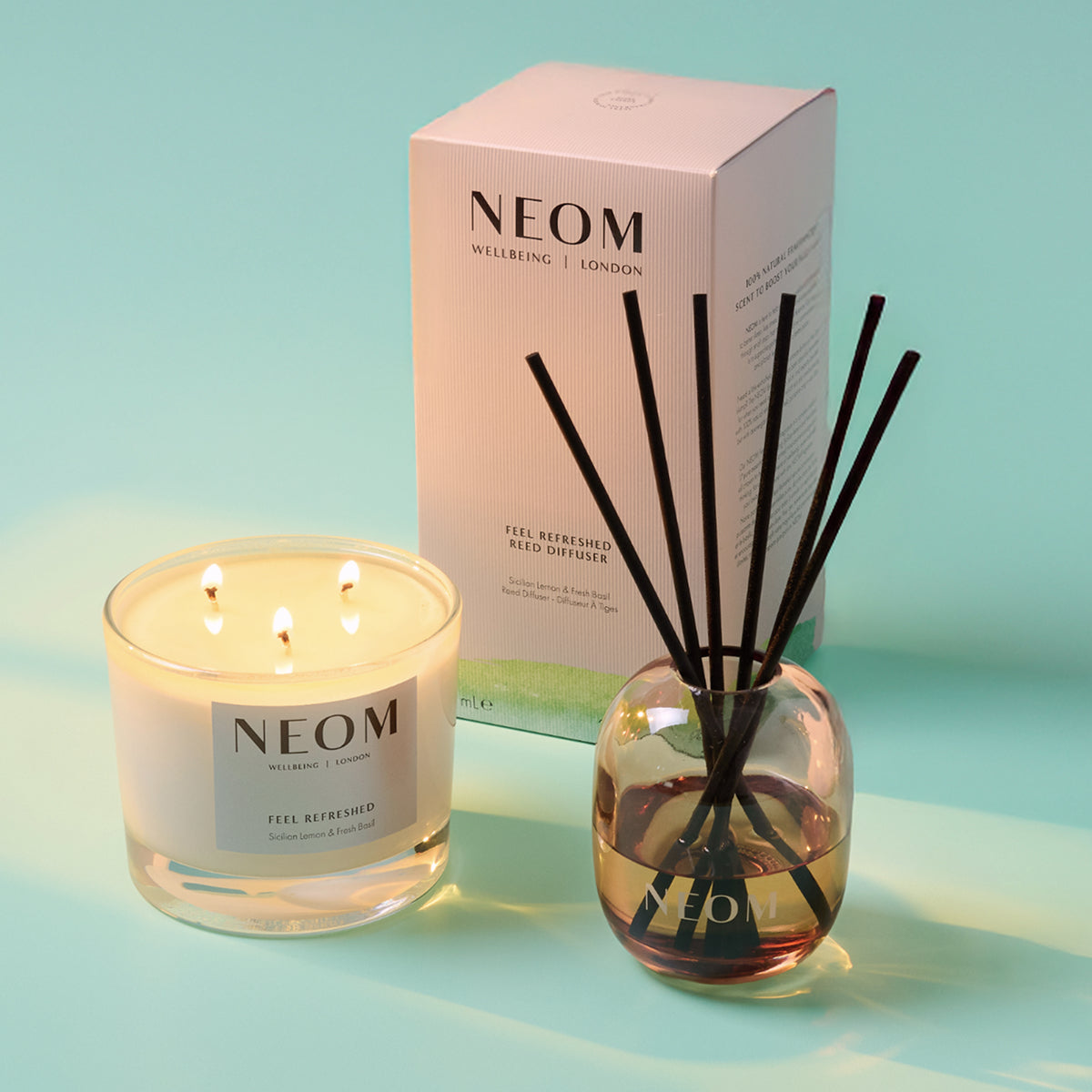NEOM Feel Refreshed candle and reed diffuser set with lemon and basil fragrance.