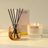 NEOM Happiness scented candle and reed diffuser.