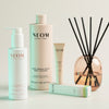 Neom products including a bottle, tube, pen and diffuser on a light background