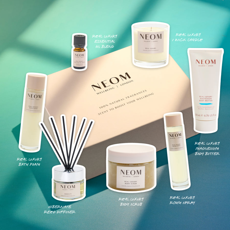 NEOM Real Luxury gift set with natural wellbeing products including candle, diffuser, oils, and body care.