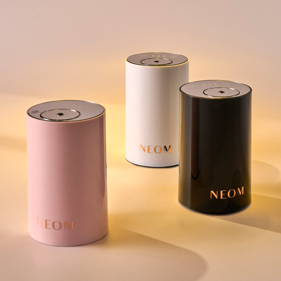 Three NEOM pod mini on a gradient background
