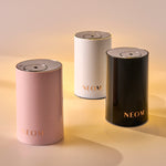 Three NEOM pod mini on a gradient background