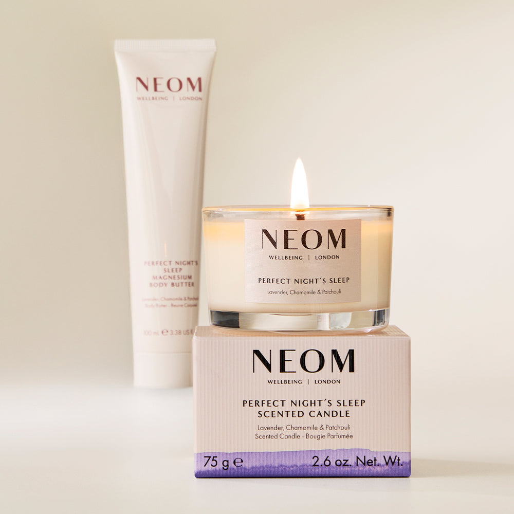 NEOM candle and body butter on a light background