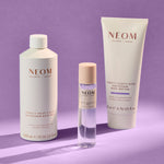NEOM bath & body products on a purple background