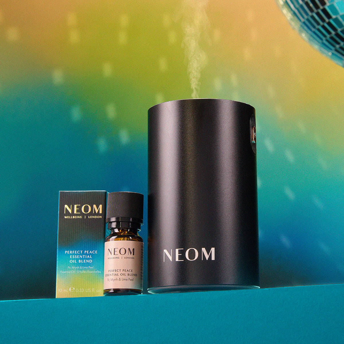 NEOM products including a diffuser, essential oil blend, and bottle on a gradient background