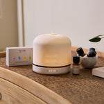 NEOM Pod Luxe with essential oils on a chest of drawers